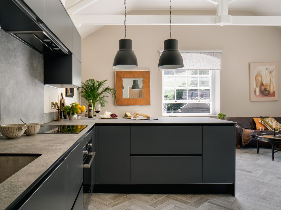 A kitchen with a central island and a window at Upper School House in Newton Abbot