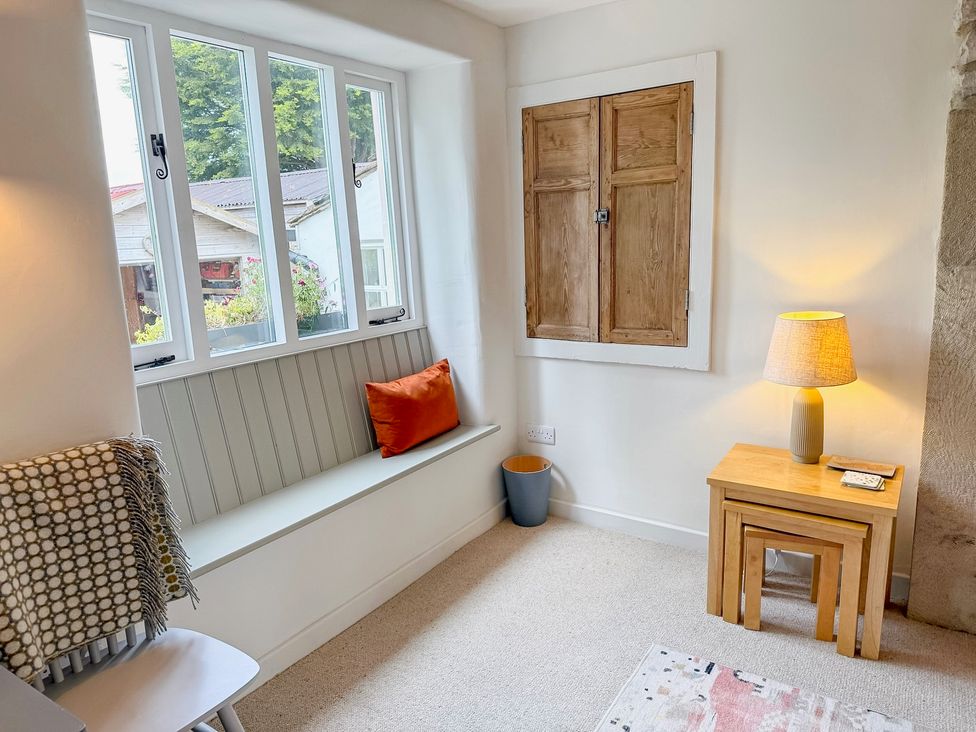 A snug with a window seat and a lamp at 7 Litton Slack in Tideswell