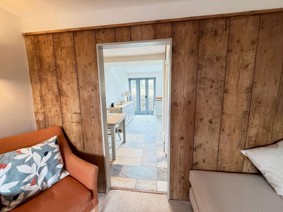 A living room featuring a sofa and an entrance to another room at 7 Litton Slack in Tideswell