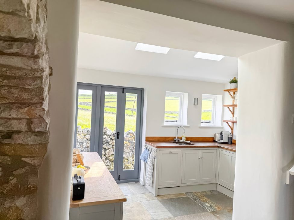 A kitchen with cabinets and a sink at 7 Litton Slack in Tideswell
