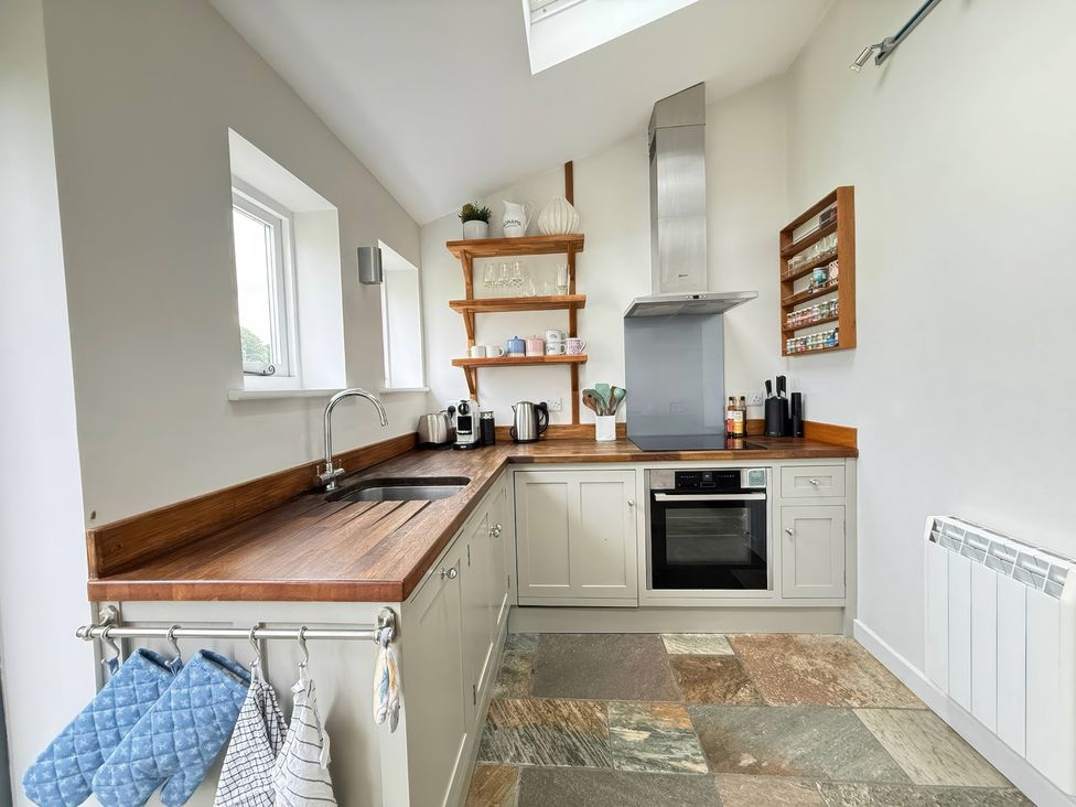 A kitchen with a sink and stove at 7 Litton Slack in Tideswell