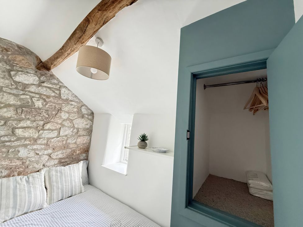 A bedroom with a bed and a closet at 7 Litton Slack in Tideswell