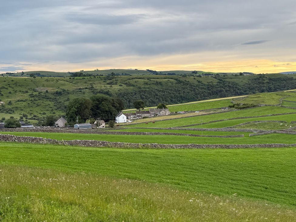 A landscape view with fields and farm buildings at 7 Litton Slack in Tideswell
