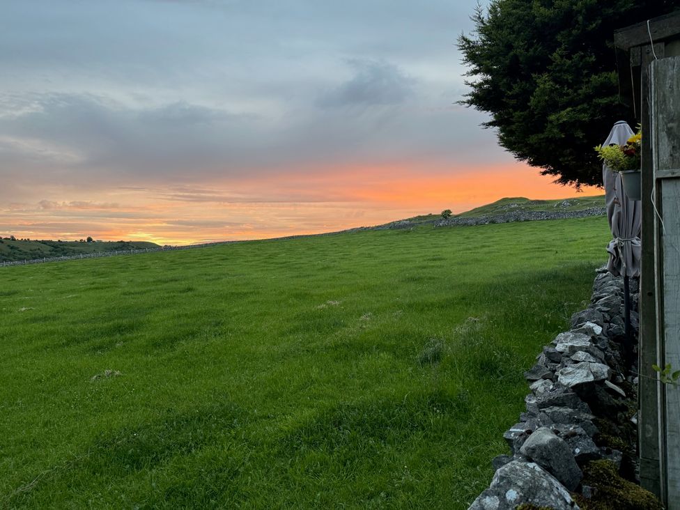 A field with grass and a sunset at 7 Litton Slack in Tideswell