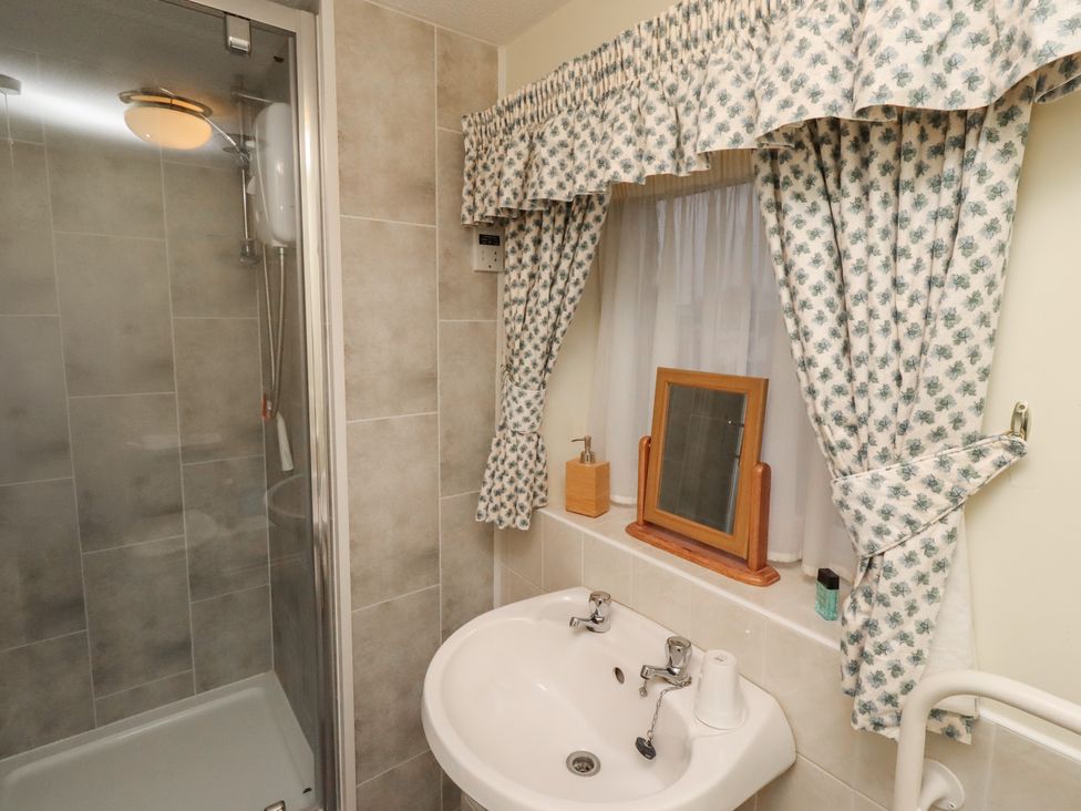A bathroom with a shower and sink at Grange Cottage in Belford
