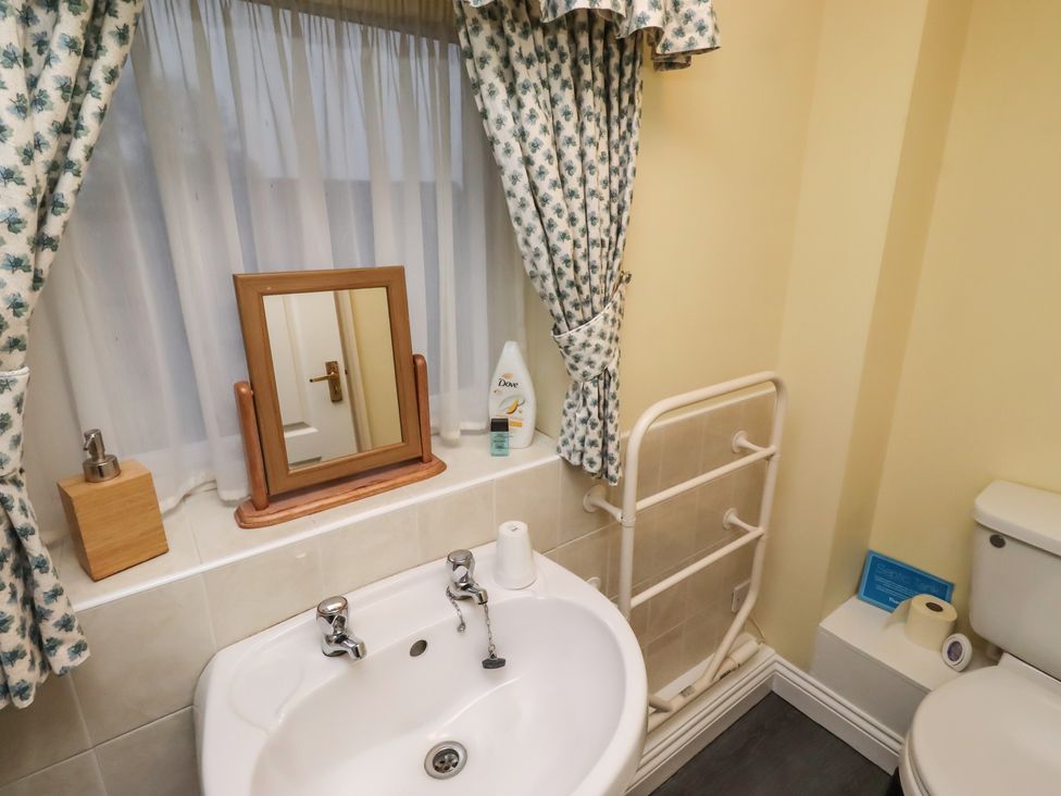 A bathroom with a sink and a toilet at Grange Cottage in Belford