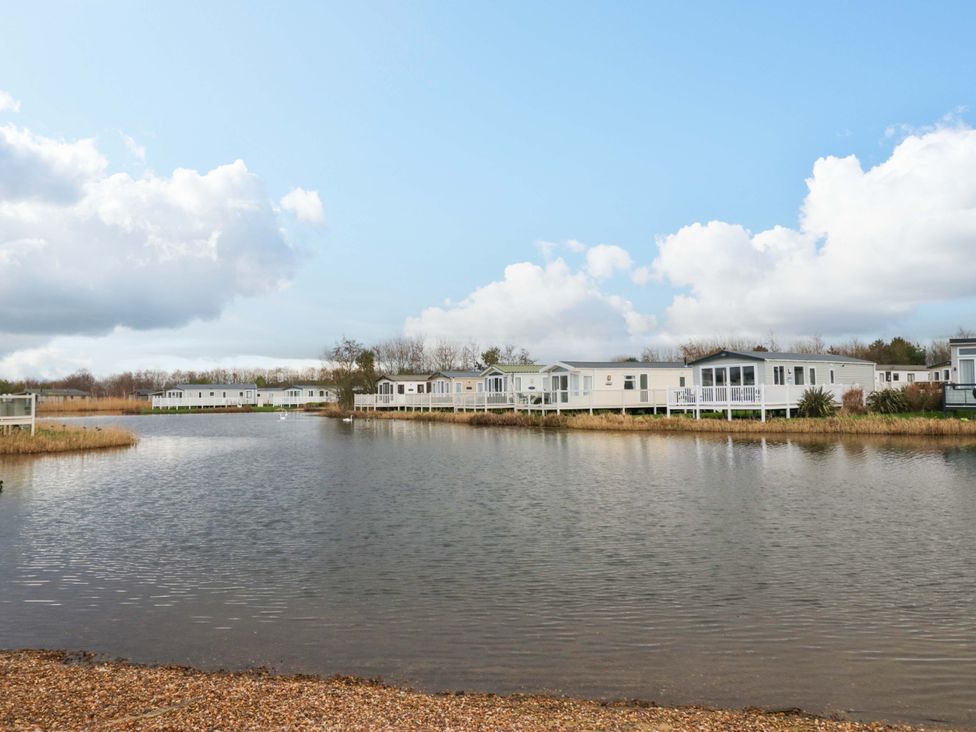 A view of caravans by a lake at 62 Guddlebeck in Flookburgh