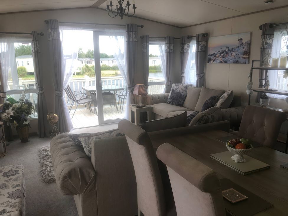 A living room with a sofa and a table at 62 Guddlebeck, Lakeland Leisure Park, Flookburgh