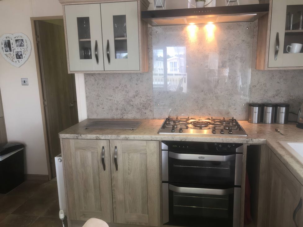 A kitchen with cabinets, gas stove, and oven at 62 Guddlebeck, Lakeland Leisure Park, Flookburgh