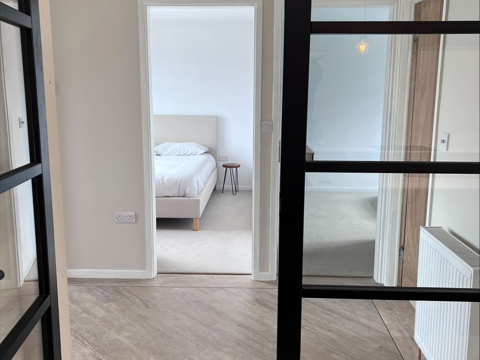 A bedroom with a bed and bedside table at 81 Lon Gogarth in Benllech