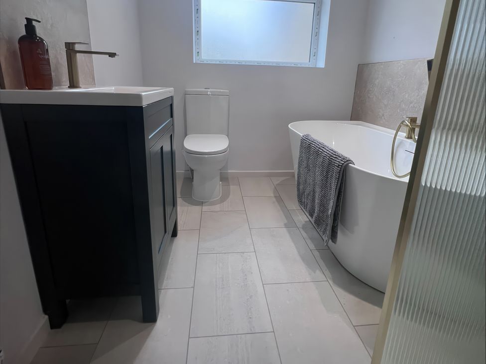 A bathroom with a sink toilet and bathtub at 81 Lon Gogarth in Benllech