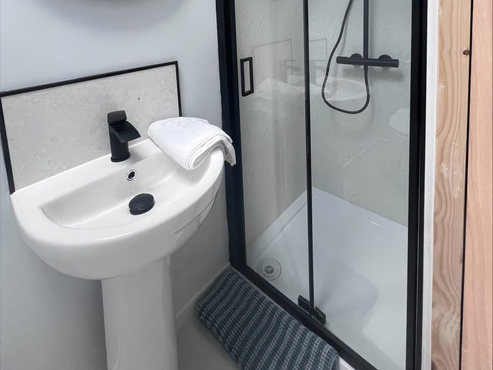 A bathroom featuring a sink and a shower enclosure at 81 Lon Gogarth in Benllech