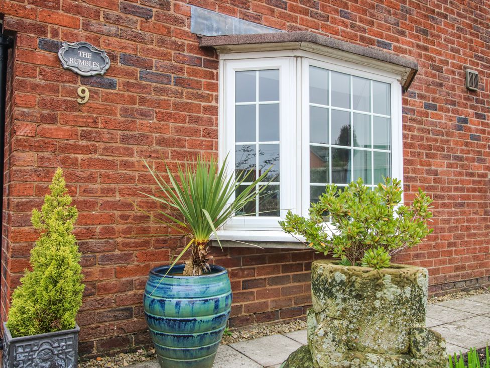 A house exterior with a window and plants at The Rumbles 