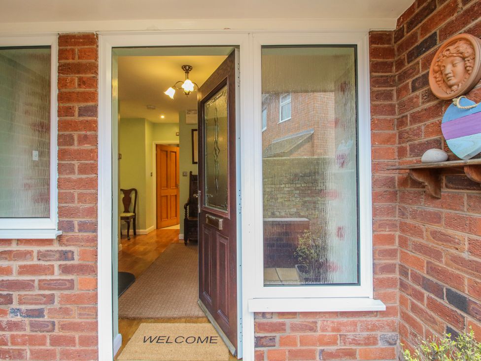 An entrance with a welcome mat and a chair at The Rumbles in 