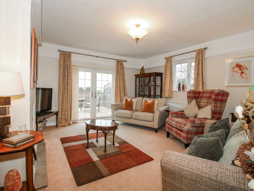 A living room with a sofa and armchairs at The Rumbles