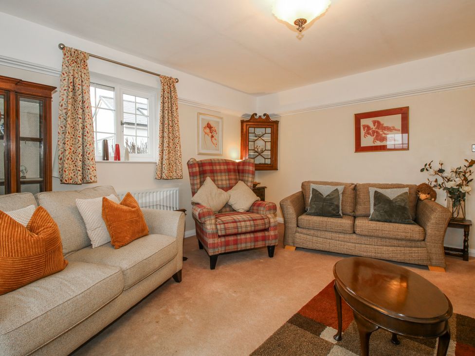 A living room with a sofa and armchair at The Rumbles in 