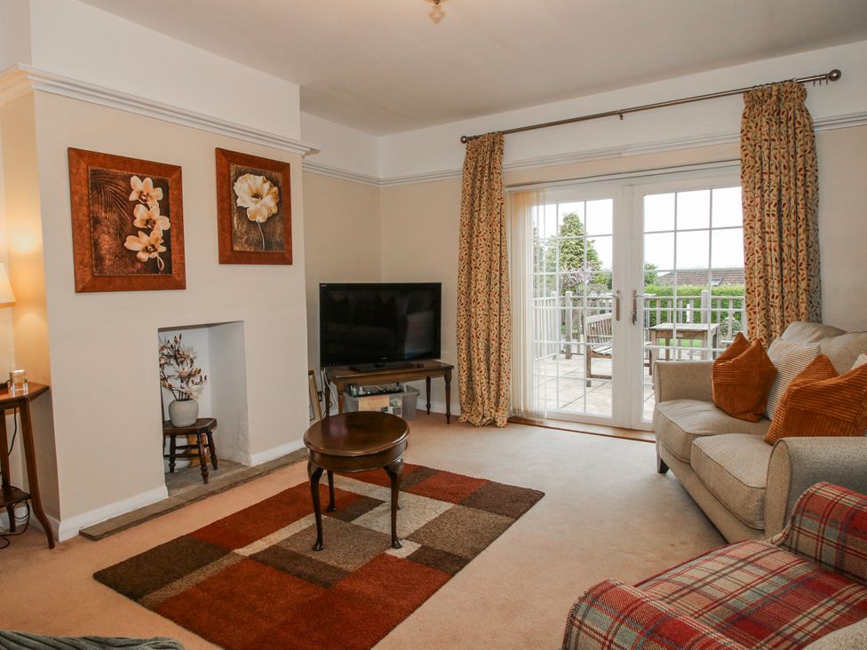 A living room with a sofa and TV at The Rumbles