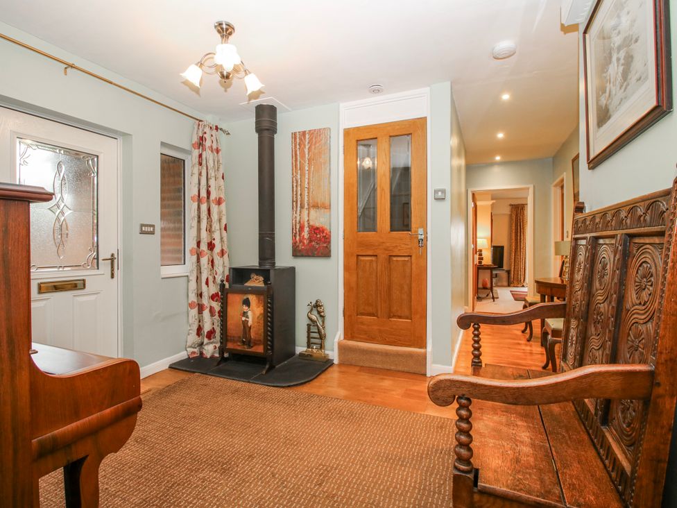 A hallway with a fireplace and seating at The Rumbles in 