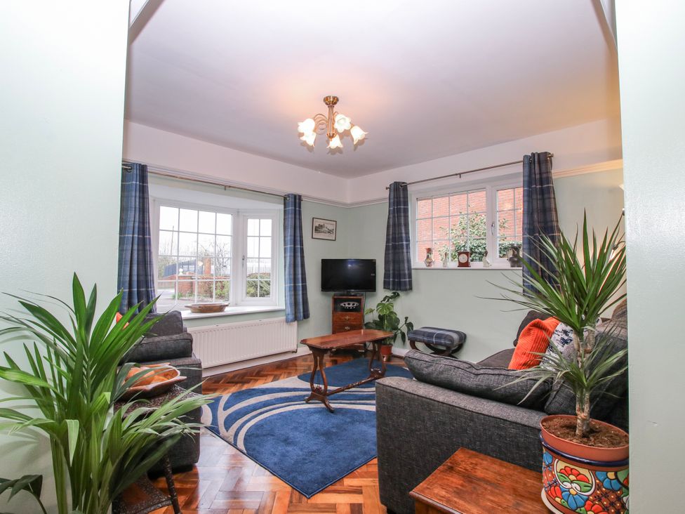 A living room with a sofa and coffee table at The Rumbles