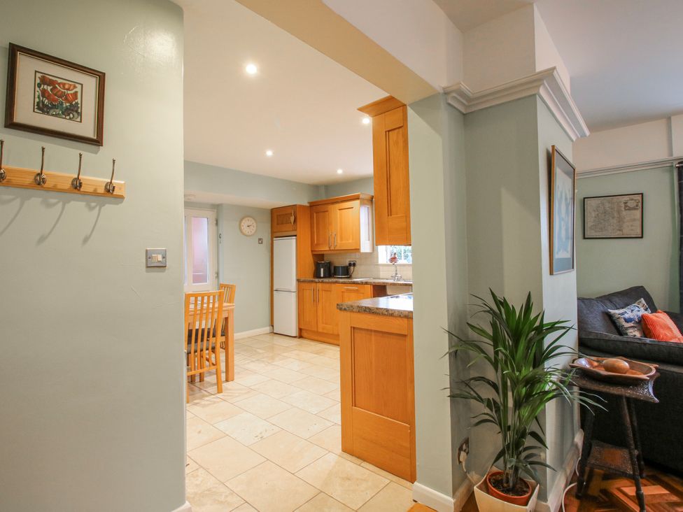 A kitchen area with dining table and chairs at The Rumbles in 