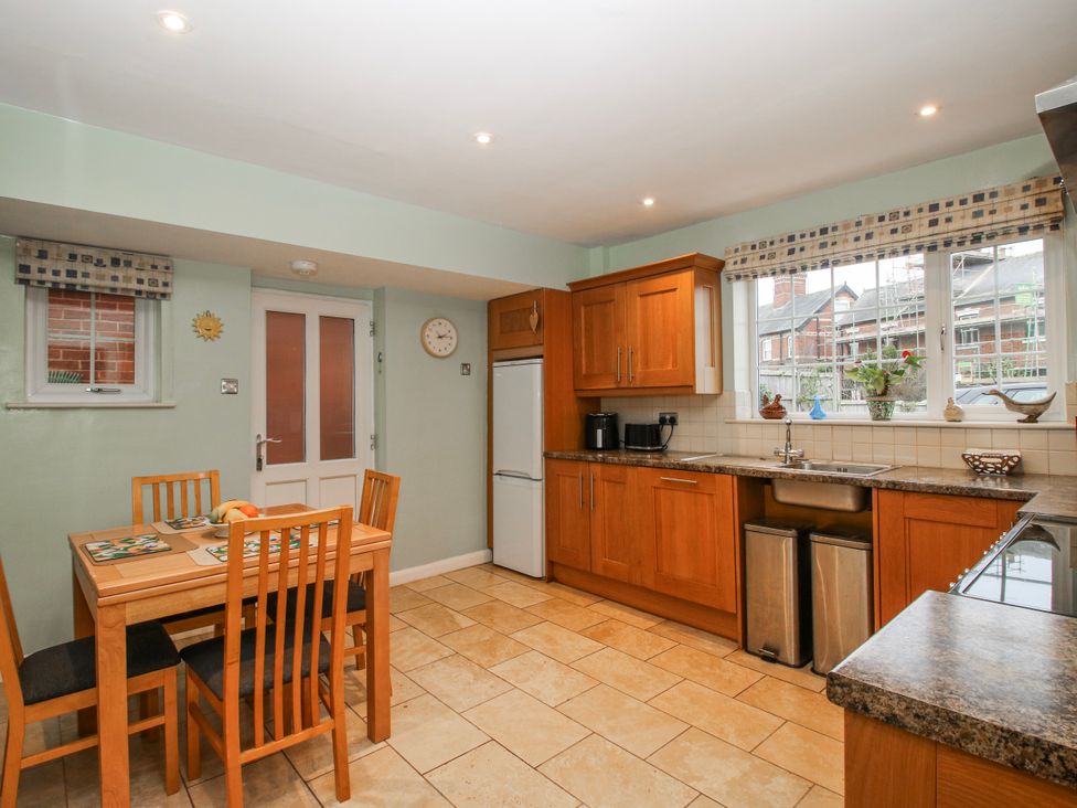 A kitchen with a table and chairs at The Rumbles