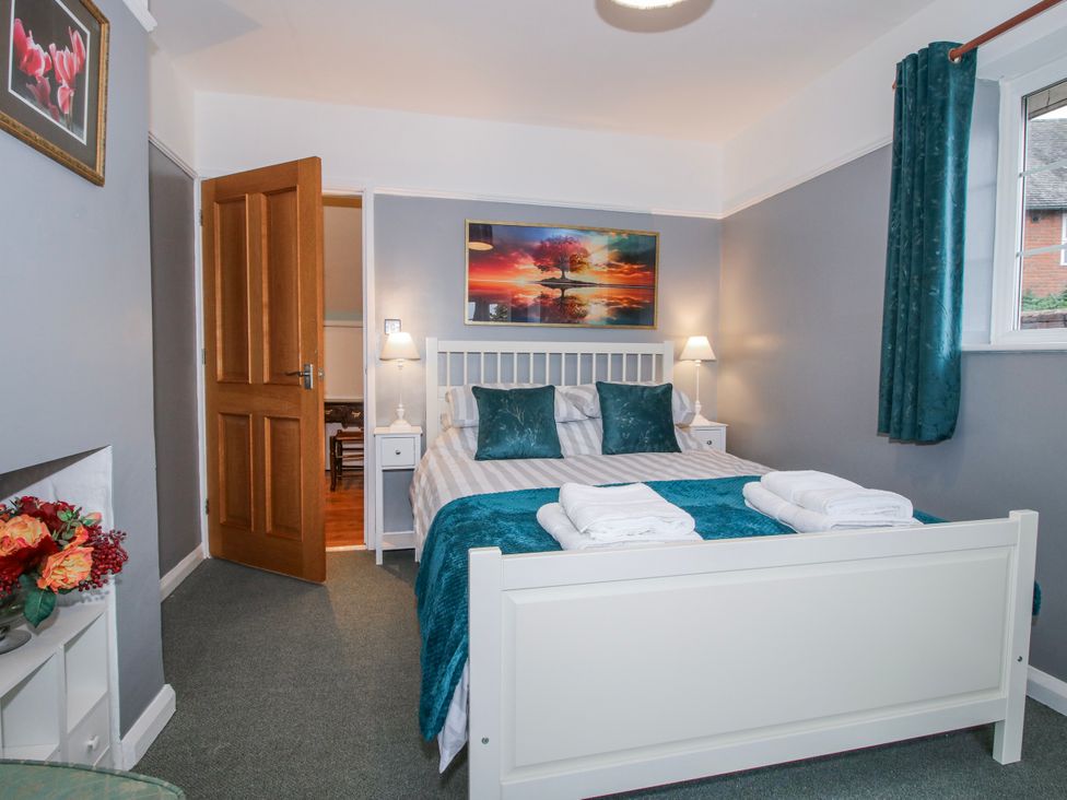 A bedroom with a bed and bedside lamp at The Rumbles 