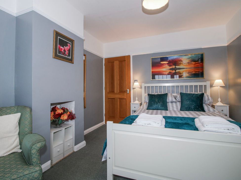 A bedroom with a bed and nightstands at The Rumbles in 