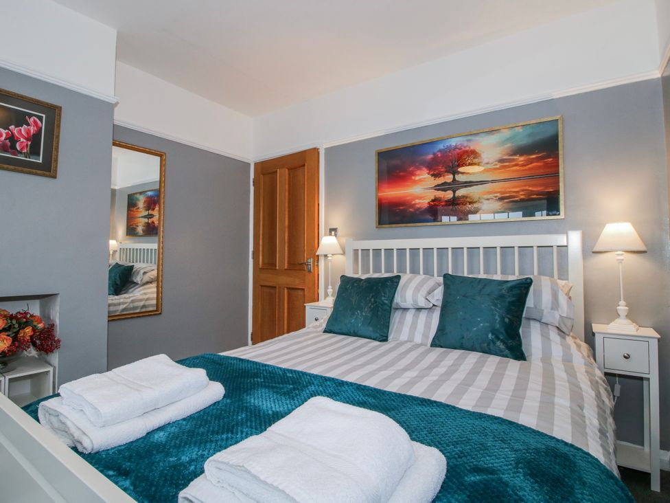 A bedroom with a bed and wall art at The Rumbles in 