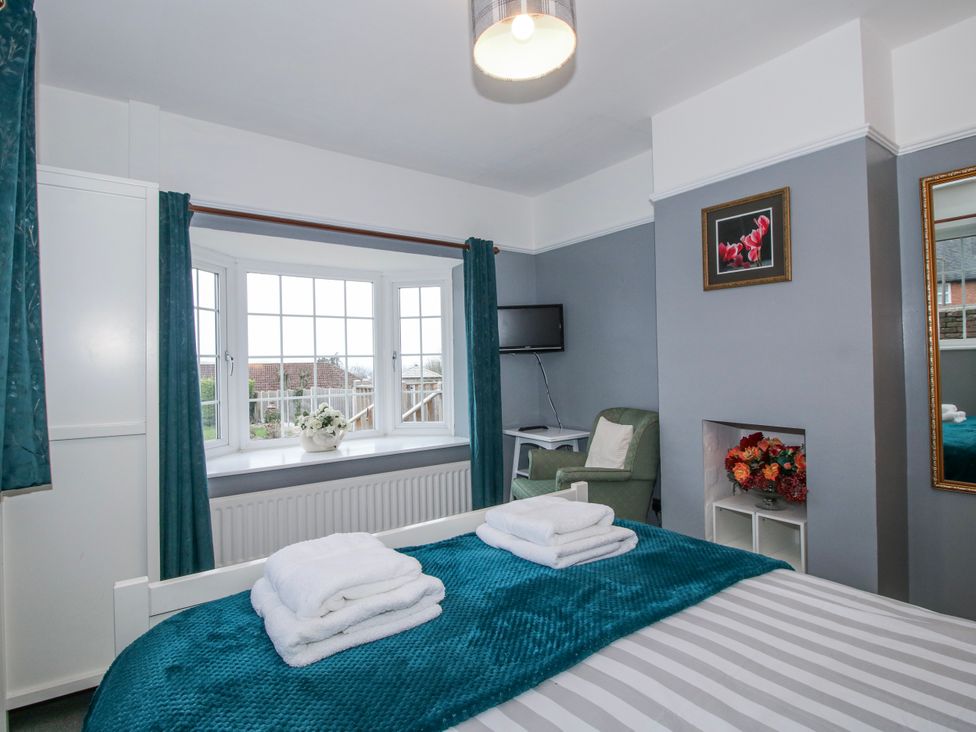 A bedroom with a bed and window at The Rumbles in 