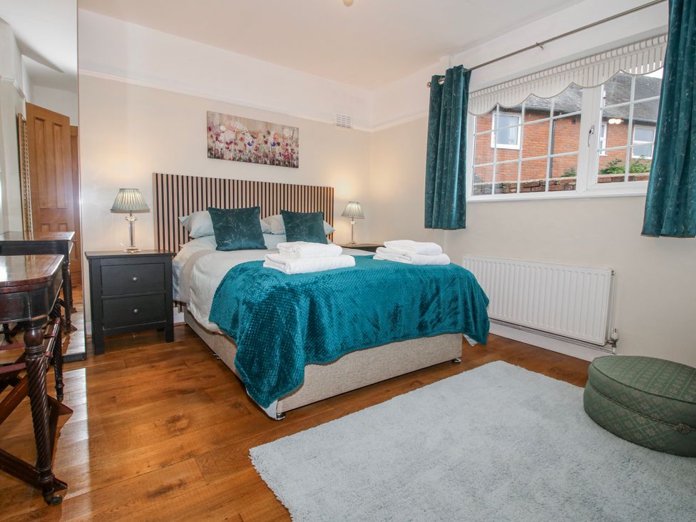 A bedroom with a bed and nightstand at The Rumbles in 