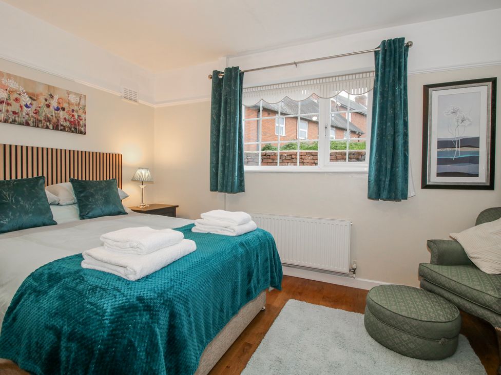 A bedroom with a bed and bedside table at The Rumbles in 