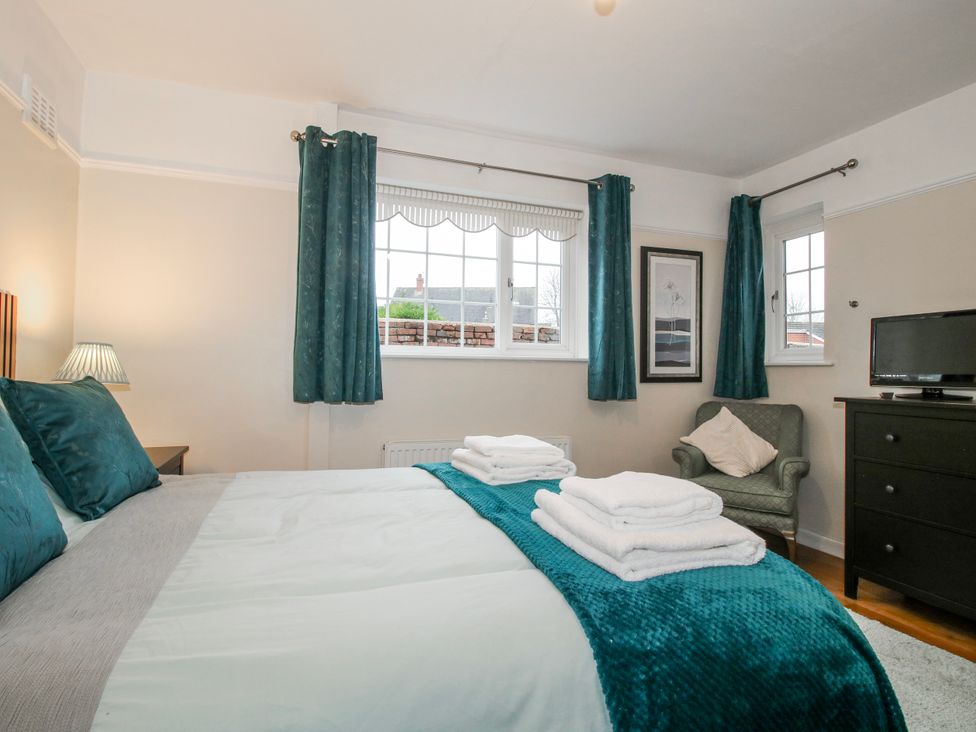 A bedroom with a bed and a television at The Rumbles