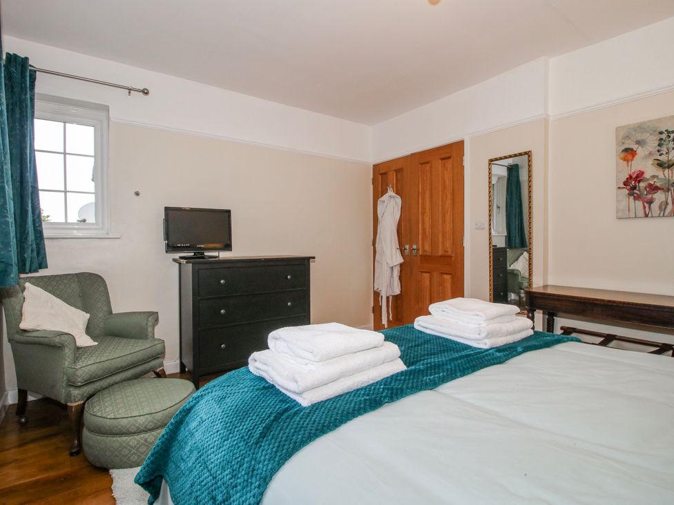 A bedroom with a bed and towels on it at The Rumbles