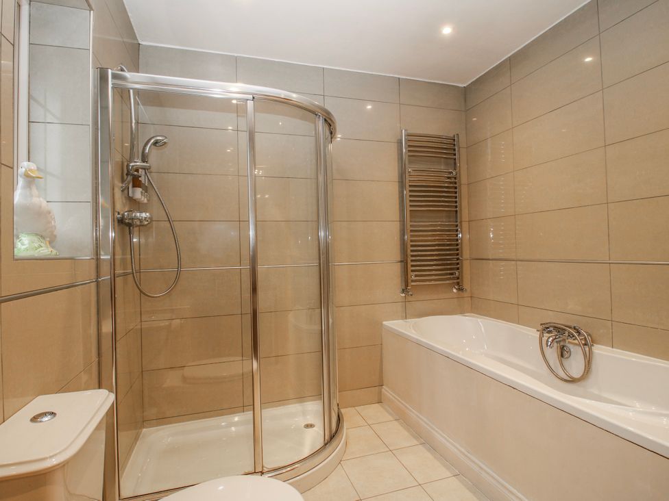 A bathroom with a shower and a bathtub at The Rumbles in 