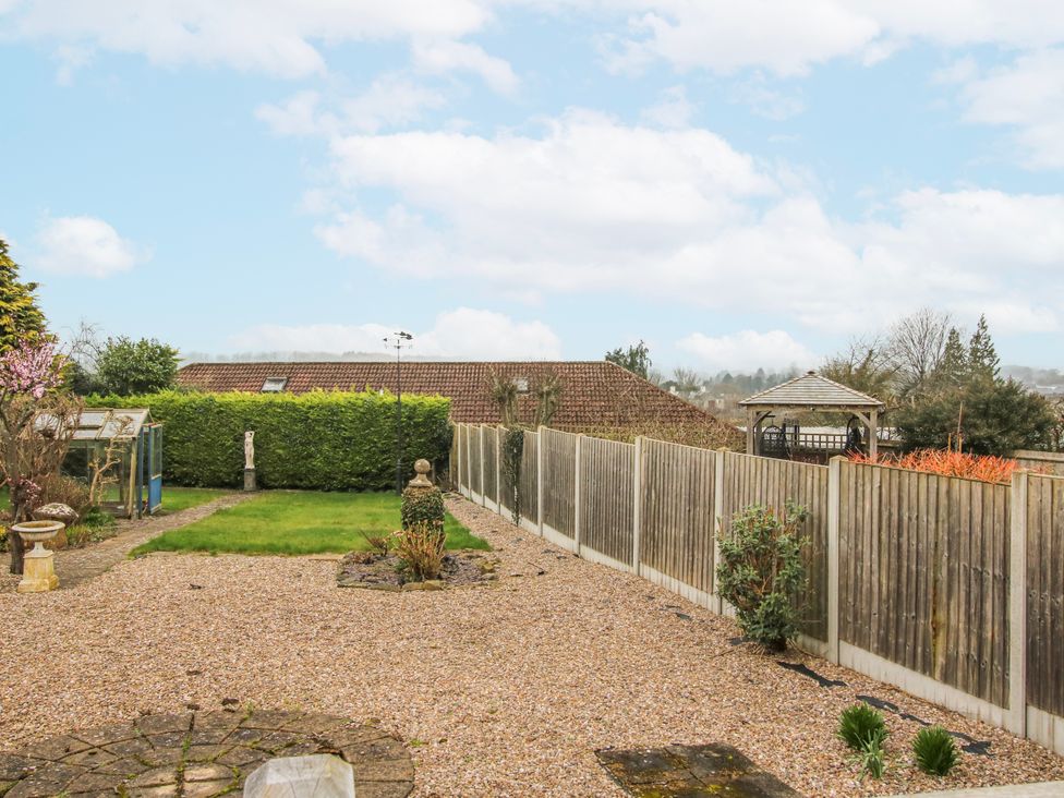 A garden with a fence and gazebo at The Rumbles in 