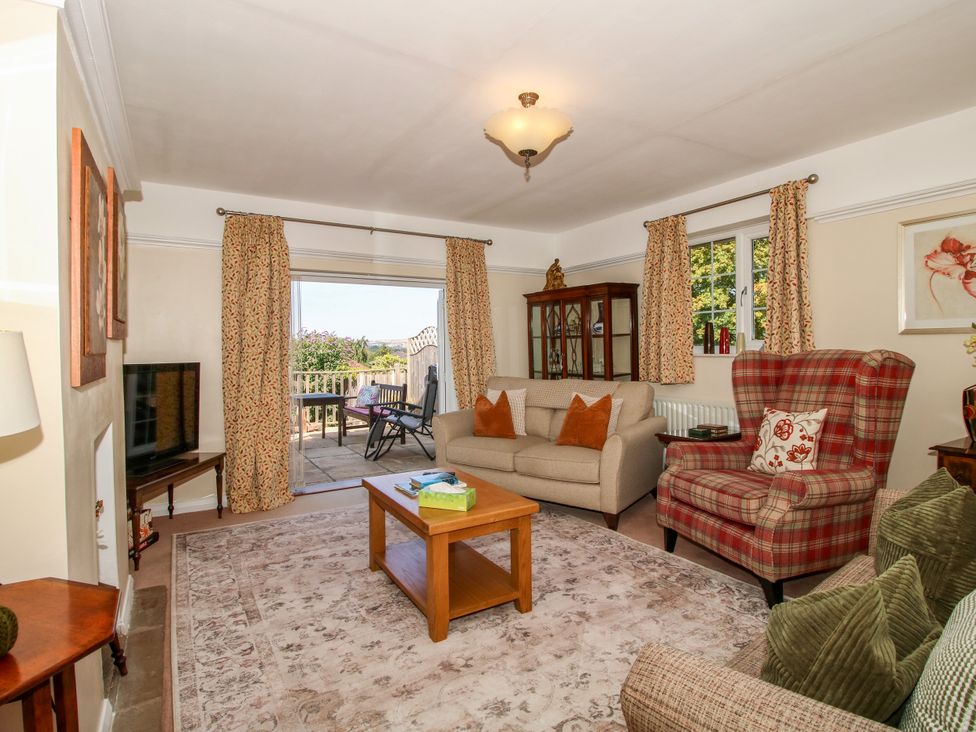 A living room with a sofa and armchair at The Rumbles in Ludlow