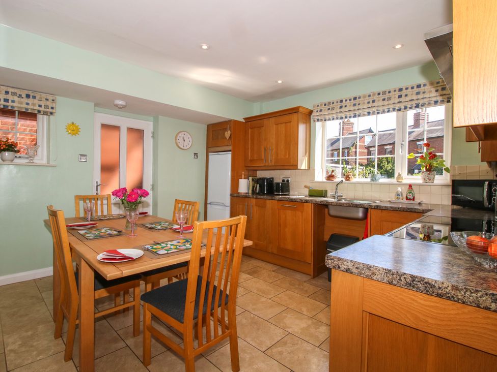 A kitchen with a dining table and chairs at The Rumbles in Ludlow