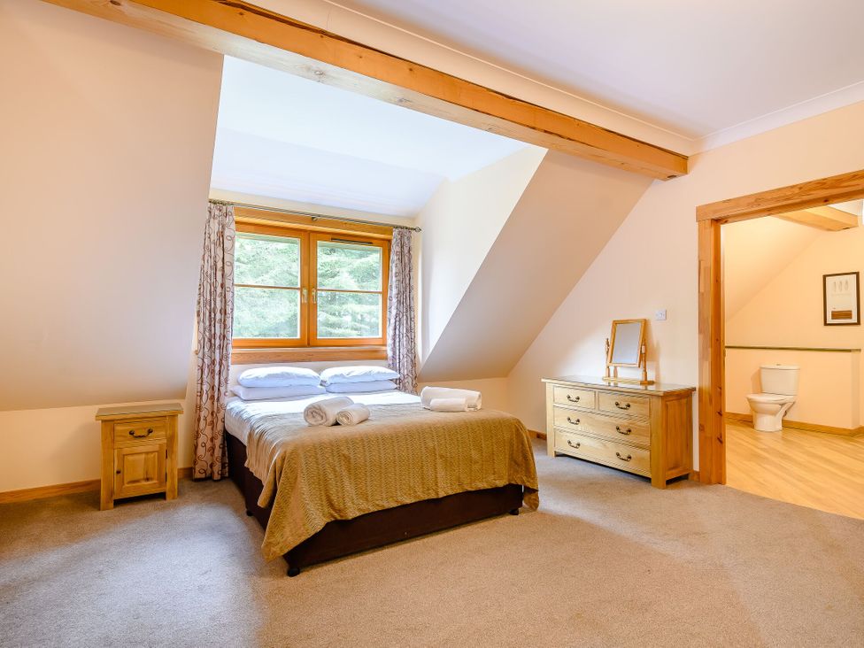 A bedroom with a bed and a dresser at Foresters Spa Plus in Dundee