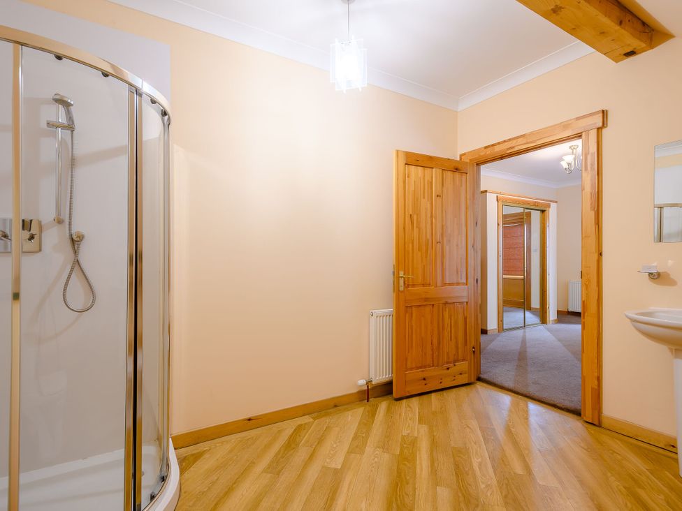 A bathroom with a shower and sink at Foresters Spa Plus in Dundee