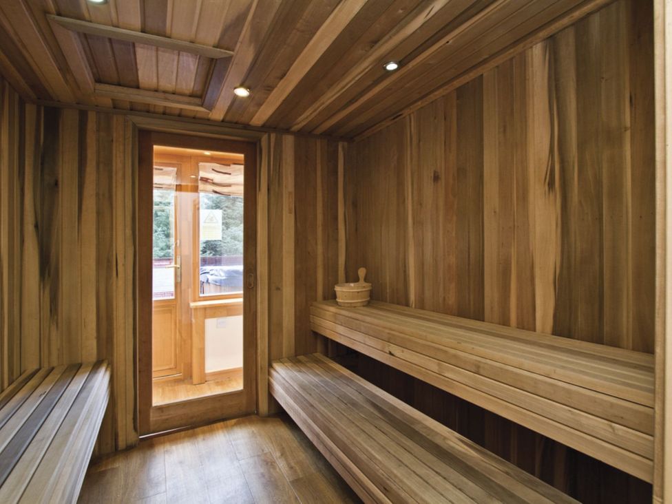 A sauna with wooden benches and walls at Foresters Spa Plus in Dundee