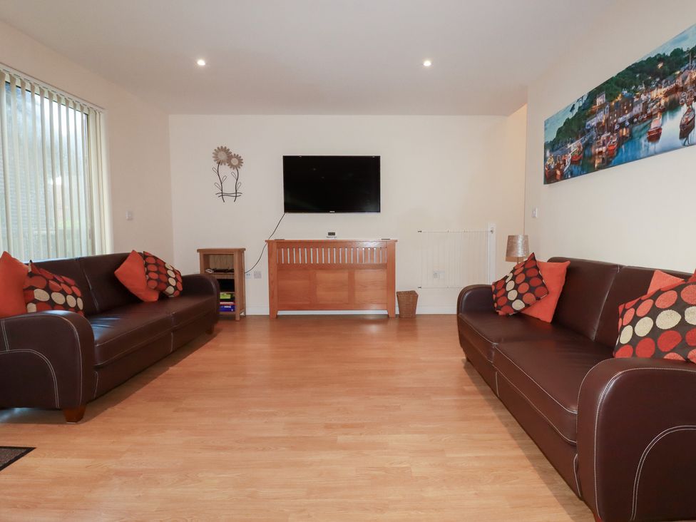 A living room with sofas and a television at 65 Benasa Lodge in Winnard's Perch near St Columb Major