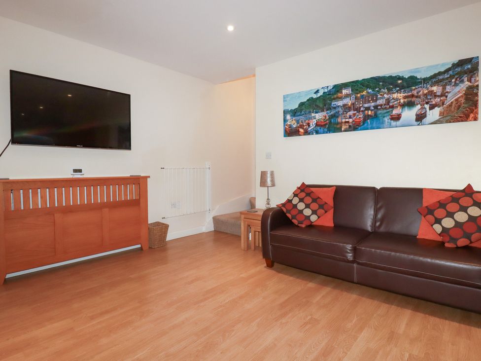 A living room with a sofa and television at 65 Benasa Lodge near St Columb Major
