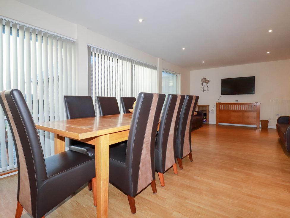A dining room with a table and chairs at 65 Benasa Lodge near St Columb Major