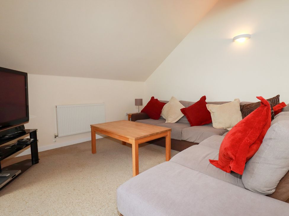 A living room with a sofa and coffee table at 65 Benasa Lodge near St Columb Major