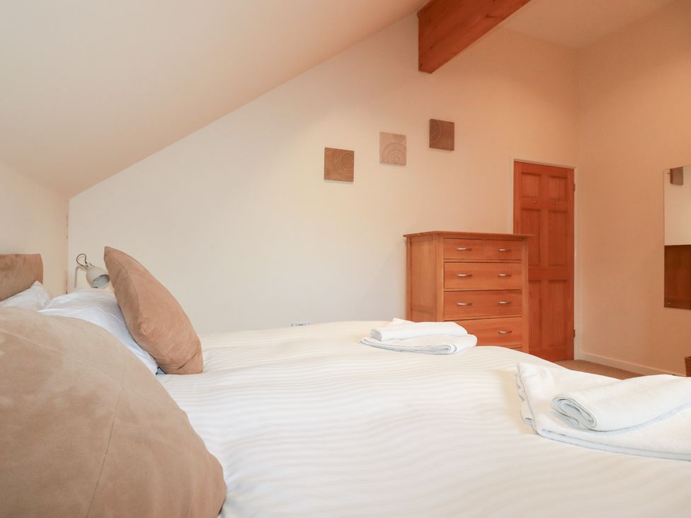 A bedroom with a bed and dresser at 65 Benasa Lodge in Winnard's Perch near St Columb Major