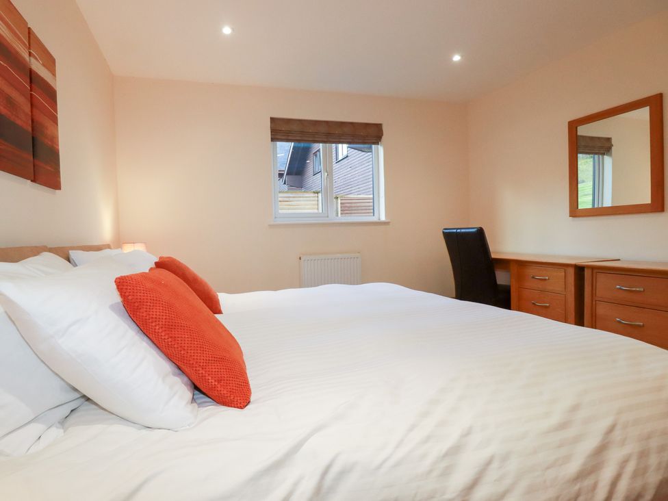 A bedroom with a bed and desk at 65 Benasa Lodge in Winnard's Perch near St Columb Major