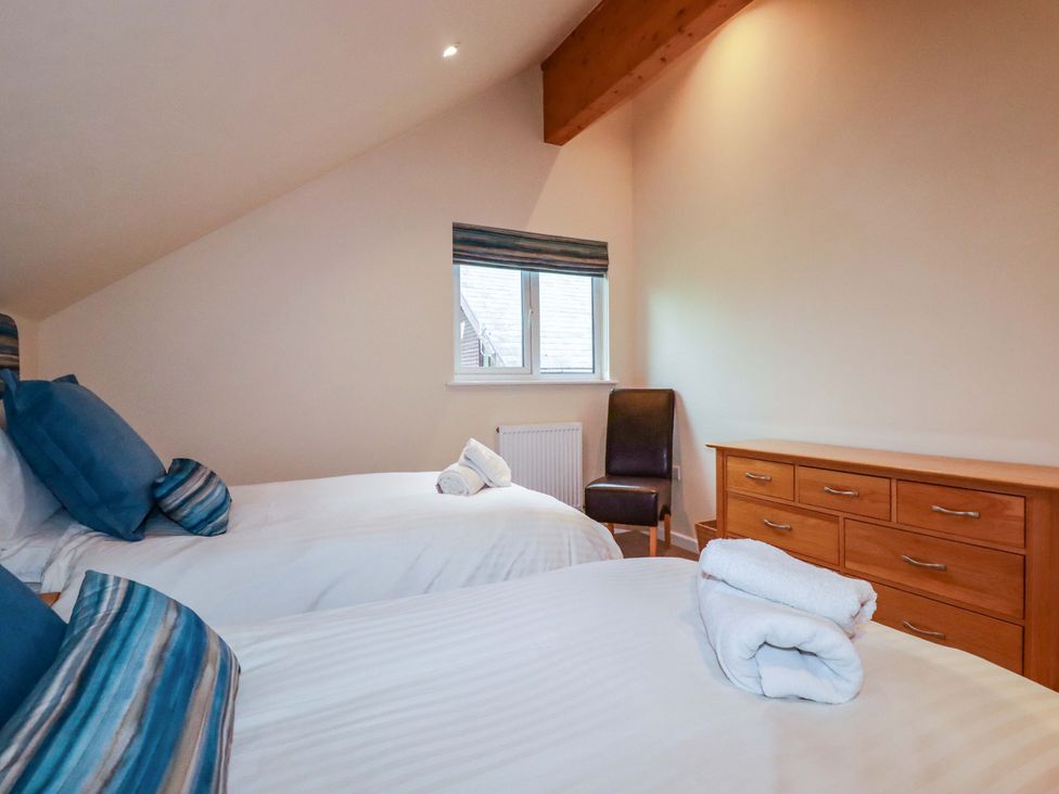 A bedroom with two beds and a window at 65 Benasa Lodge, Winnard's Perch near St Columb Major