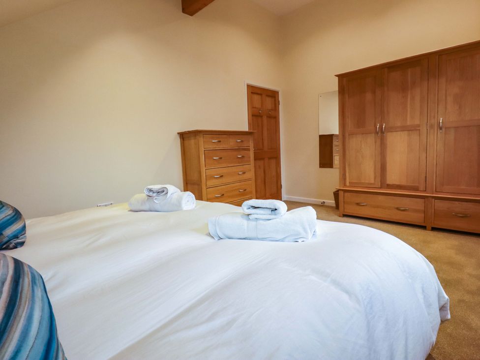 A bedroom with bed and furniture at 65 Benasa Lodge near St Columb Major