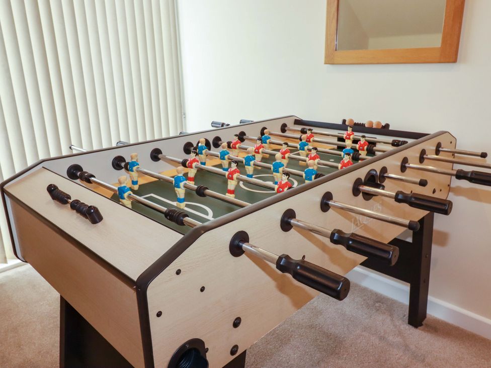 A game room with a foosball table at 65 Benasa Lodge in Winnard's Perch near St Columb Major