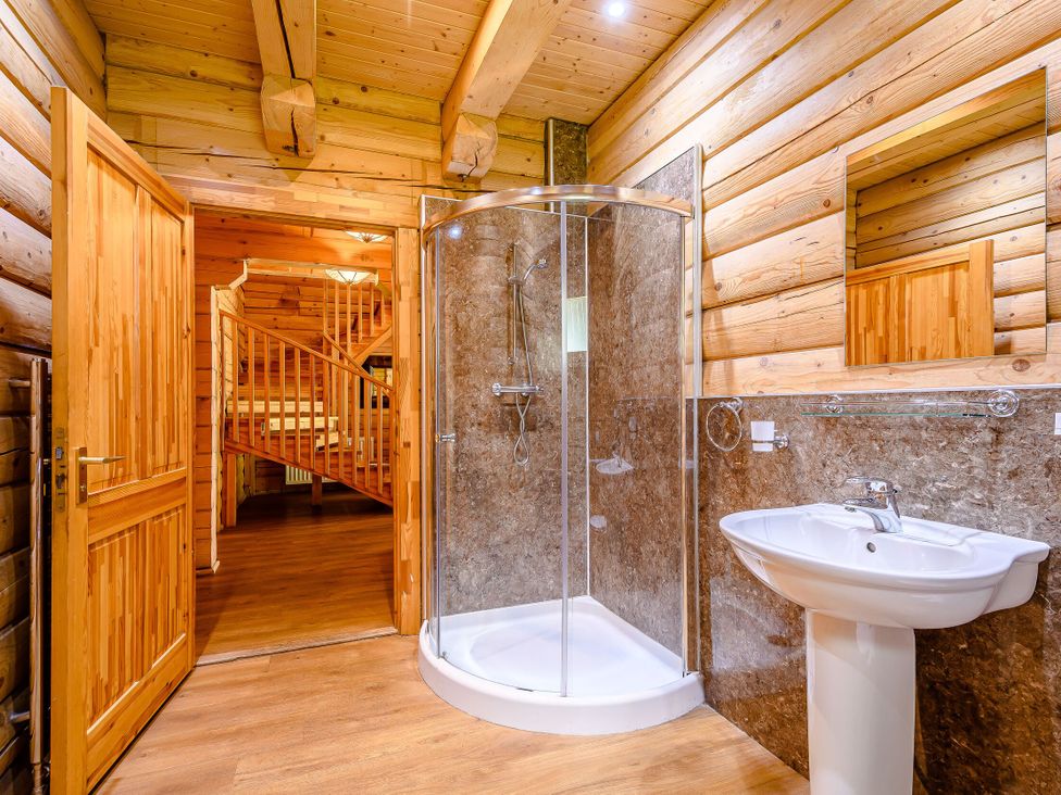 A bathroom with a shower and sink at Foresters Spa Plus (Pet) Dundee